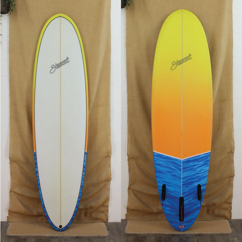 Deck and bottom view of a used Stewart 2Fun Mid Length with Yellow fading into orange and then a wavy blue on the bottom and the rails with a sand finish 