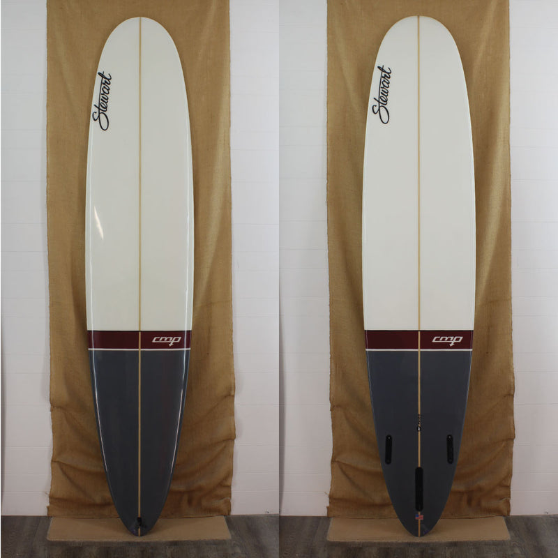 Deck and bottom view of a used Stewart CMP EPS Long board with Gloss and polish finish and a grey paint job on the bottom quater of the board with a marron stripe above the grey and solid white on the top half 