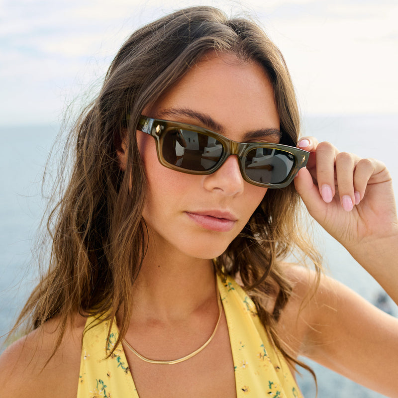 Girl wearing green framed dar sunglasses