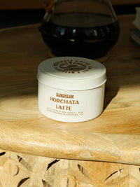 Jar of Sundream Horchata Latte candle on a wooden surface