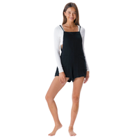 Woman wearing a black and white long-sleeve romper on a white background
