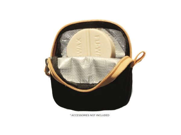 A black FIX MANUFACTURING surf wax wallet with a white wax bar inside, featuring a tarpaulin lined compartment and a slip pocket, with a quality YKK zipper.