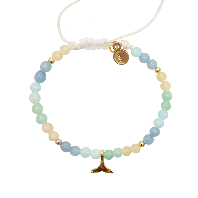 Beaded bracelet with palm tree charm on a white background
