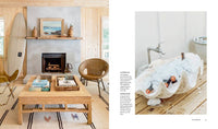 Living room with wooden coffee table and fireplace, and a bathroom with a large shell sink.