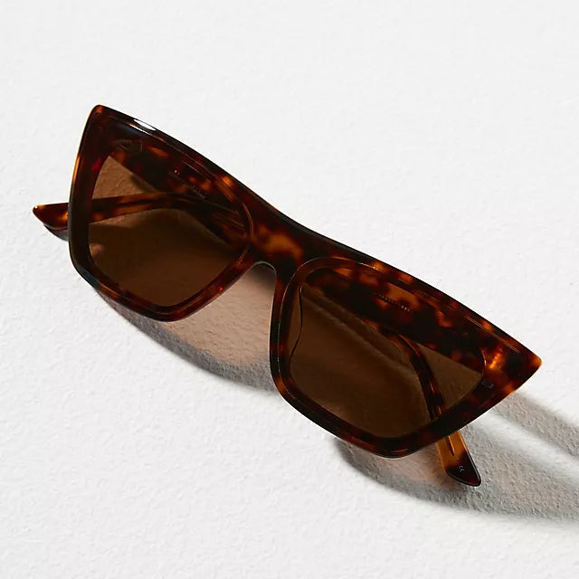 Tortoiseshell sunglasses with brown lenses on a white background