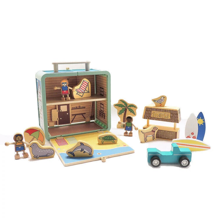 Toy set with a suitcase, beach-themed furniture, and figures on a white background