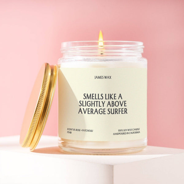 Candle in a glass jar with a label on a pink background