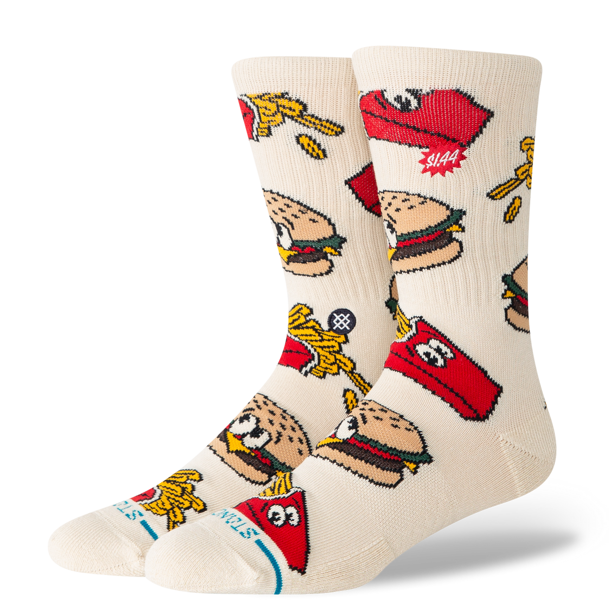A pair of crew socks in a warm off-white/cream color, featuring a colorful cartoon pattern of burgers, french fries, and red Stutz logos.