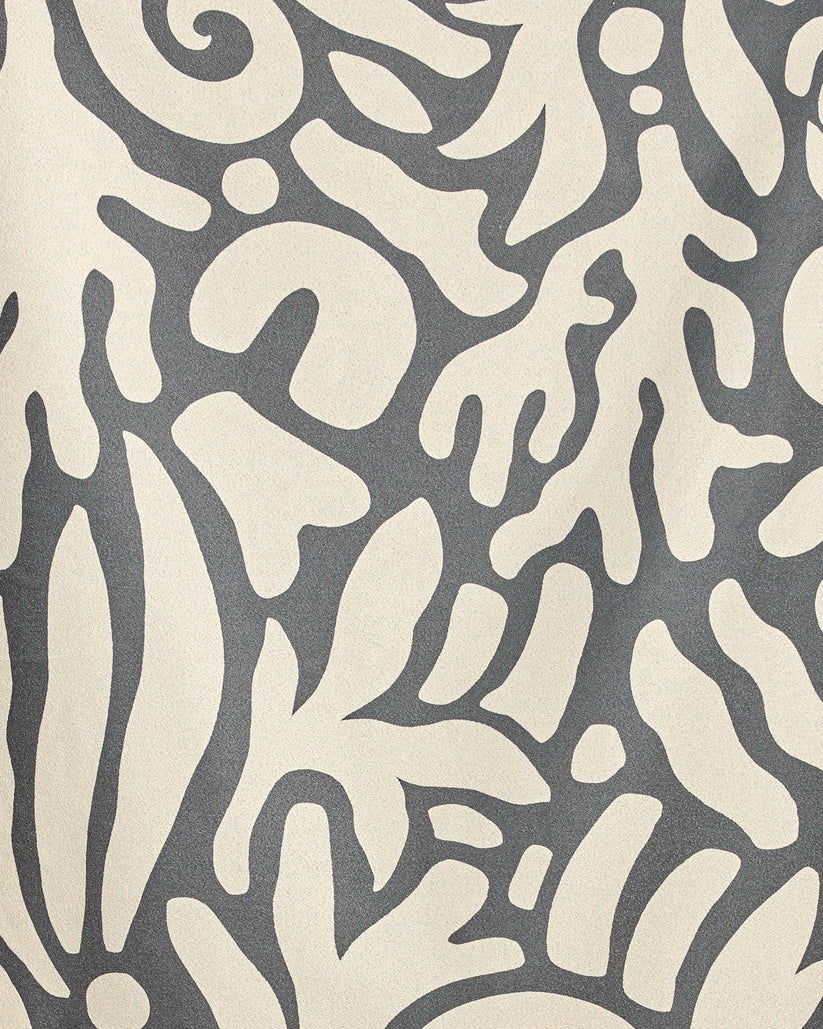 Patterned fabric with abstract leaf design on a gray background