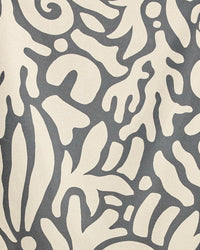 Patterned fabric with abstract leaf design on a gray background