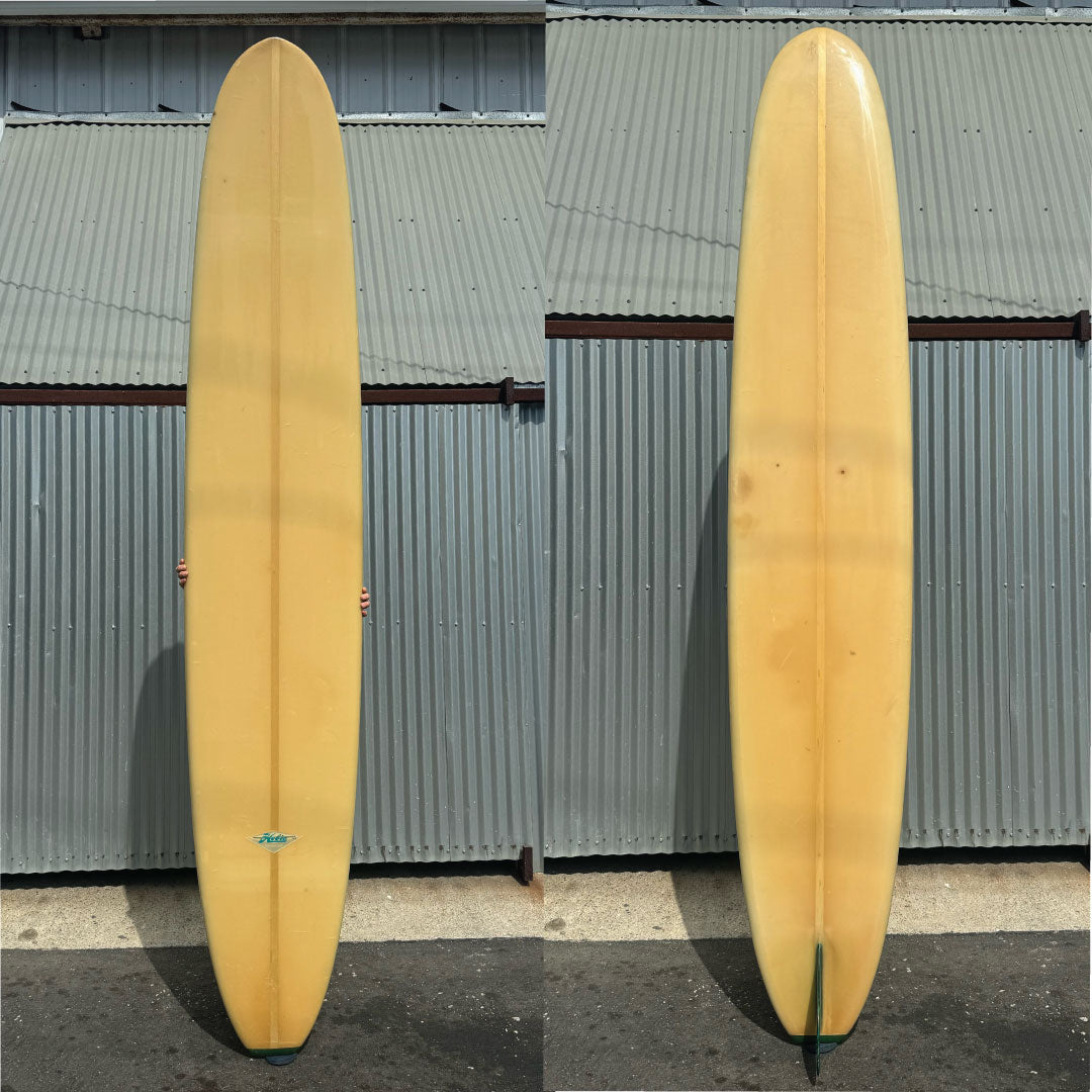 hobie longboard lightly yellow with a green glass on fin and tail block