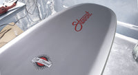 detail bottom view of the nose of the Stewart HydroCush Redline 11 soft top longboard surfboard with beveled rails and grey bottom with red logos