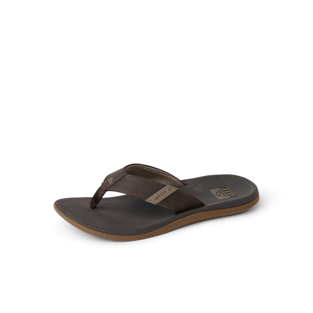 A single dark brown leather thong sandal with a contoured dark brown footbed and a tan outsole, shown from a side angle on a white background.