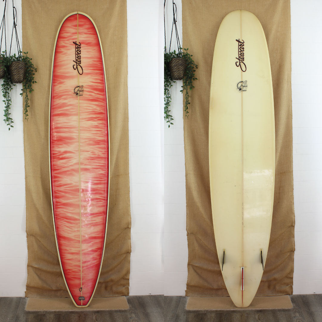 Deck and Bottom View of a Used stewart lsp longboard with red and white paint on the deck clear bottom gloss and polish 