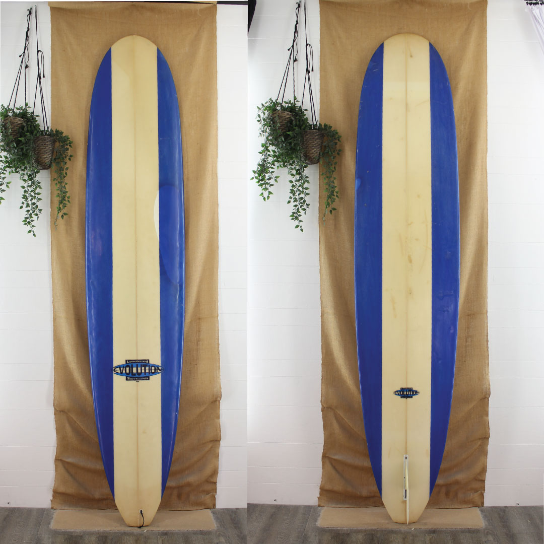 USED Evolution 9'6" x 23 1/4" x 3 1/4" Poly Longboard with retor blue rail panels 
