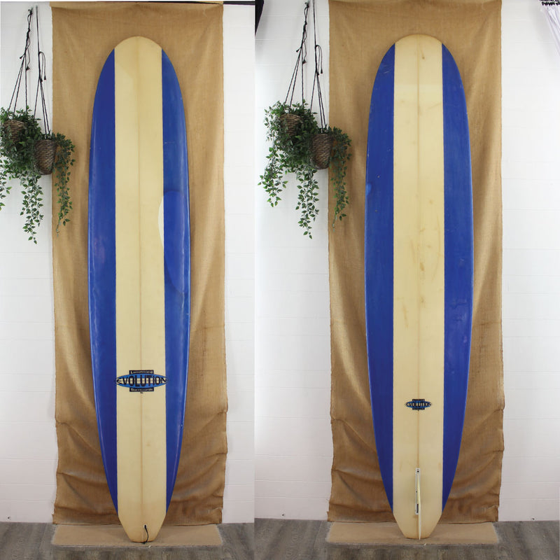 USED Evolution 9'6" x 23 1/4" x 3 1/4" Poly Longboard with retor blue rail panels 