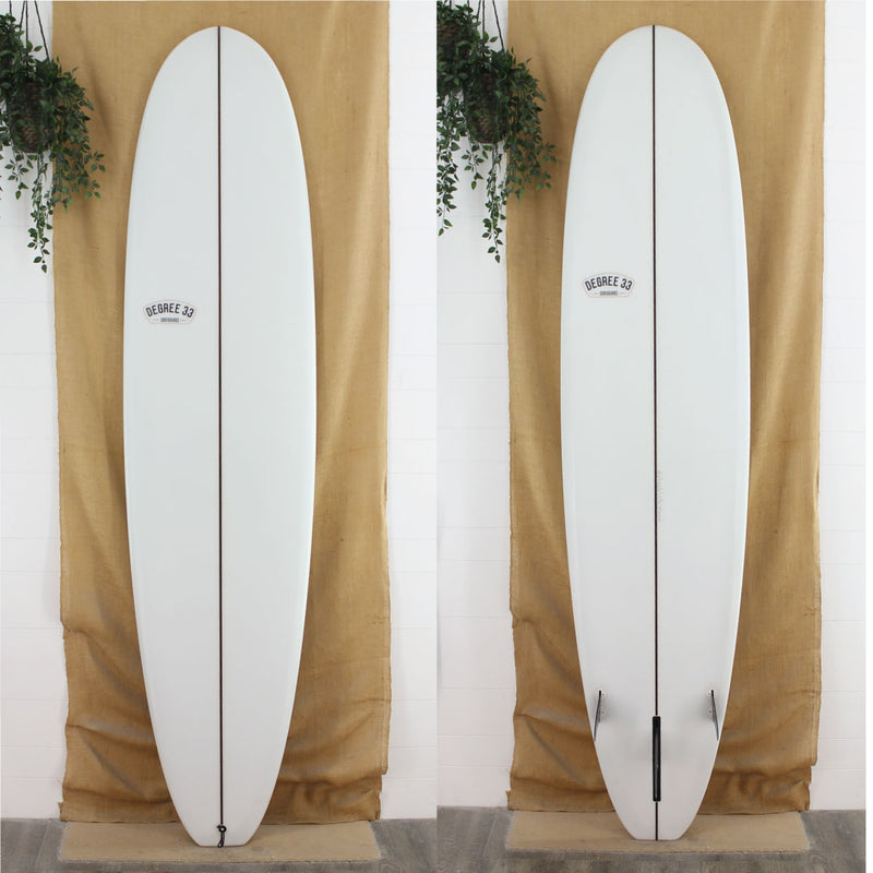 white surfboard with black stringer and black logos