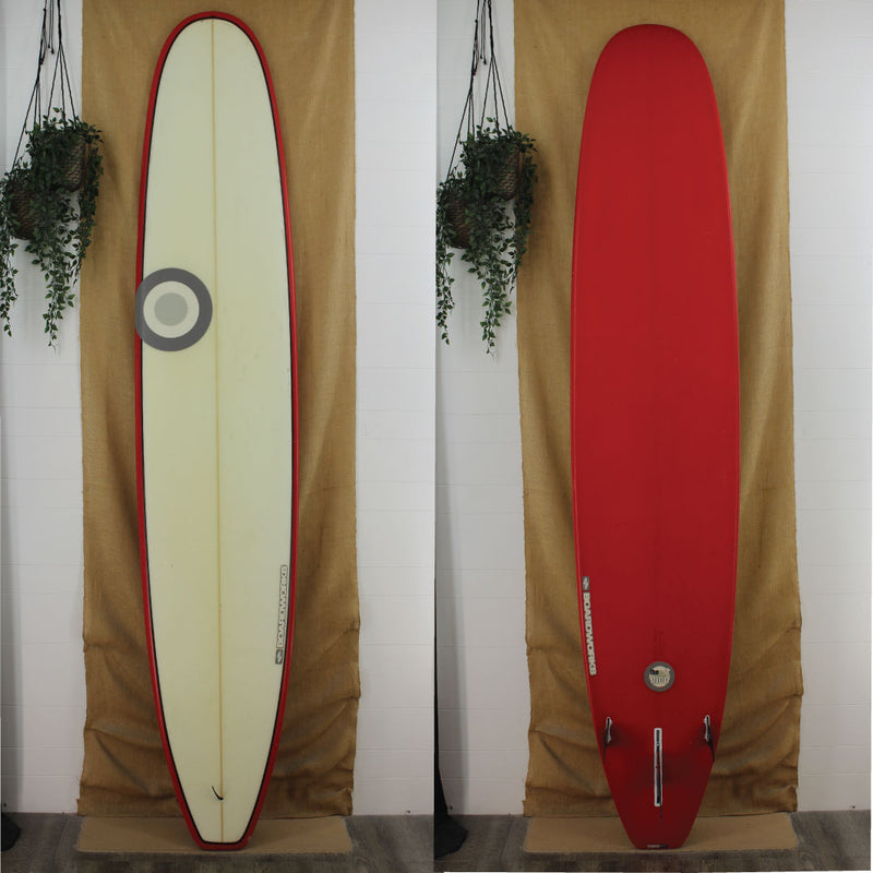 red bottom and rails longboard with black pinline