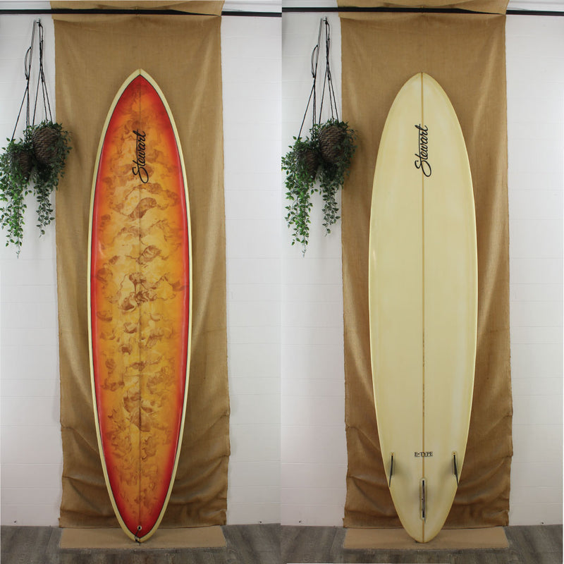 stewart clydesdale longboard surfboard with red orange paint swirl on deck clear bottom