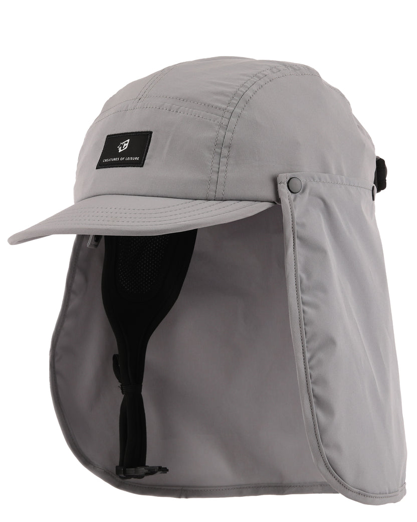 A light gray outdoor cap with an attached neck flap and chin strap, shown on a plain white background. A small black brand patch on the front 