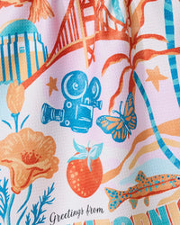 Colorful fabric with nature-themed designs and 'Greetings from' text.