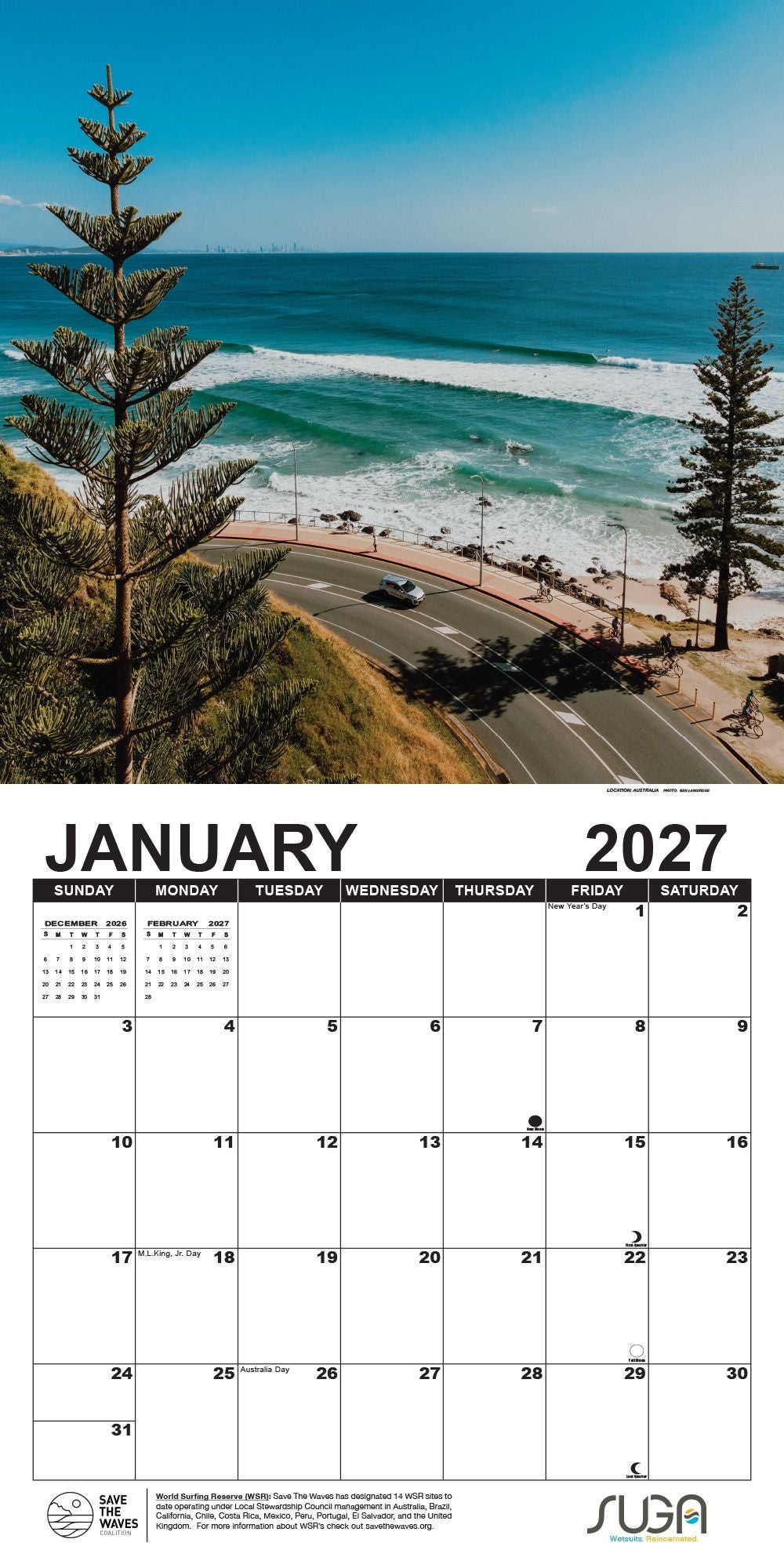 A vertical 2027 January wall calendar page featuring a coastal landscape photograph of turquoise ocean waves, a winding road, pine trees, and a blue sky, with a large monthly calendar grid below.