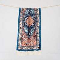 Decorative scarf with intricate patterns and fringes on a white background