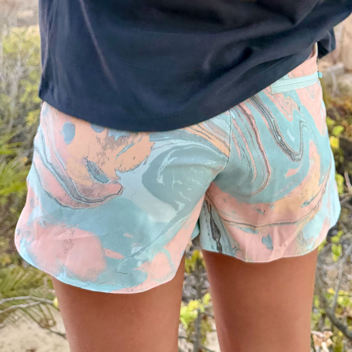 Marbled shorts worn by a person in a natural setting