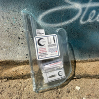 Plastic packaging with a label on a concrete surface with graffiti.