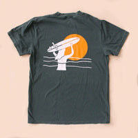 Dark green t-shirt with a graphic of a hand holding a surfboard against an orange sun on a beige background