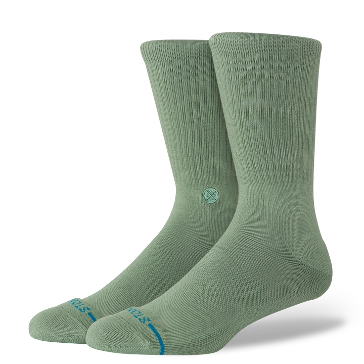 Pair of sage green socks with a brand logo on a white background