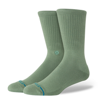 Pair of sage green socks with a brand logo on a white background