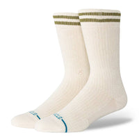 Pair of cream socks with green and blue accents on a white background