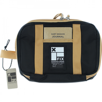 A black and beige FIX MANUFACTURING surf field kit bag with a label reading 'SURF SESSION JOURNAL', including a key and leash string attached to it.
