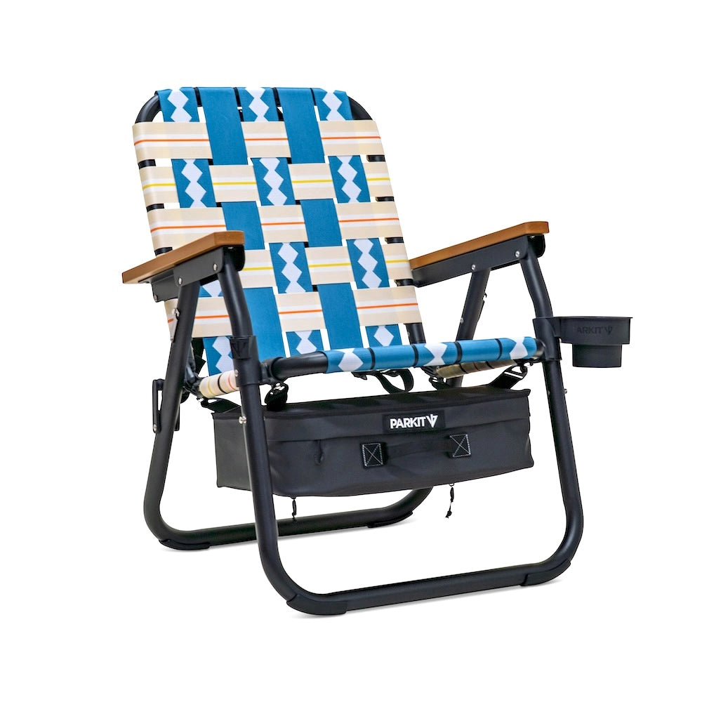Foldable chair with patterned seat and wooden armrests on a white background