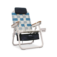 Beach chair with blue and white pattern and black bag on a white background