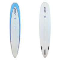 Two views of a surfboard on a plain white background: a full-length top view on the left with a white body, light blue graphic area, blue side stripes, and black script branding; a rear three-quarter view on the right showing the tail fin mounts and the same branding.