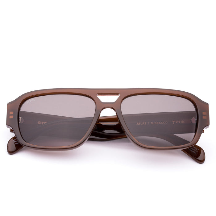 Brown sunglasses with dark lenses on a white background