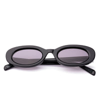 Sunglasses with black frame and grey lenses on a black  background