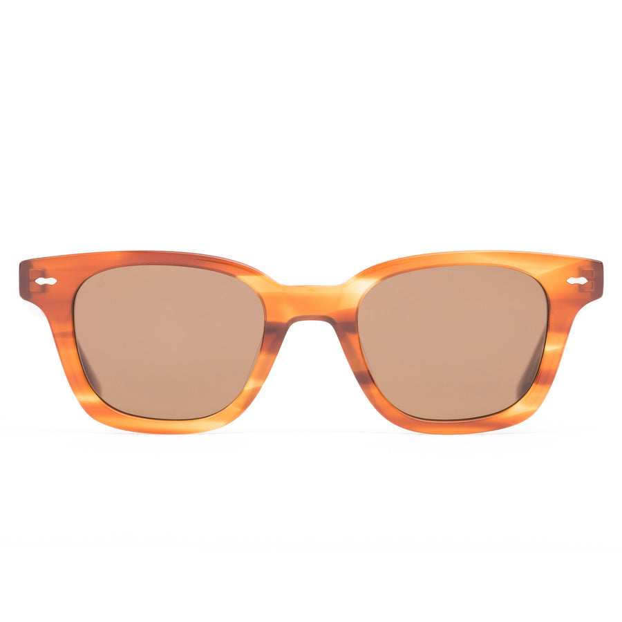 Sunglasses with tortoiseshell frame and brown lenses on a white background