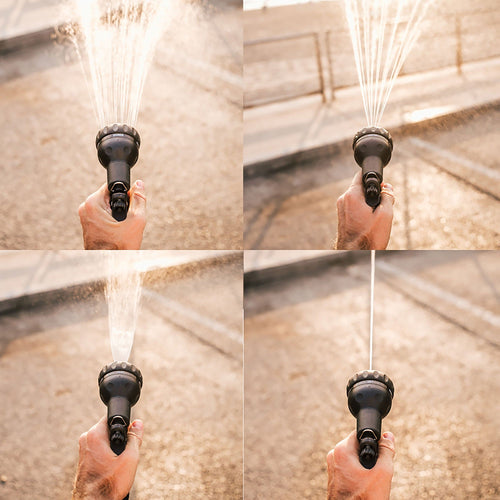 Black garden hose nozzle spraying water in a close-up shot.