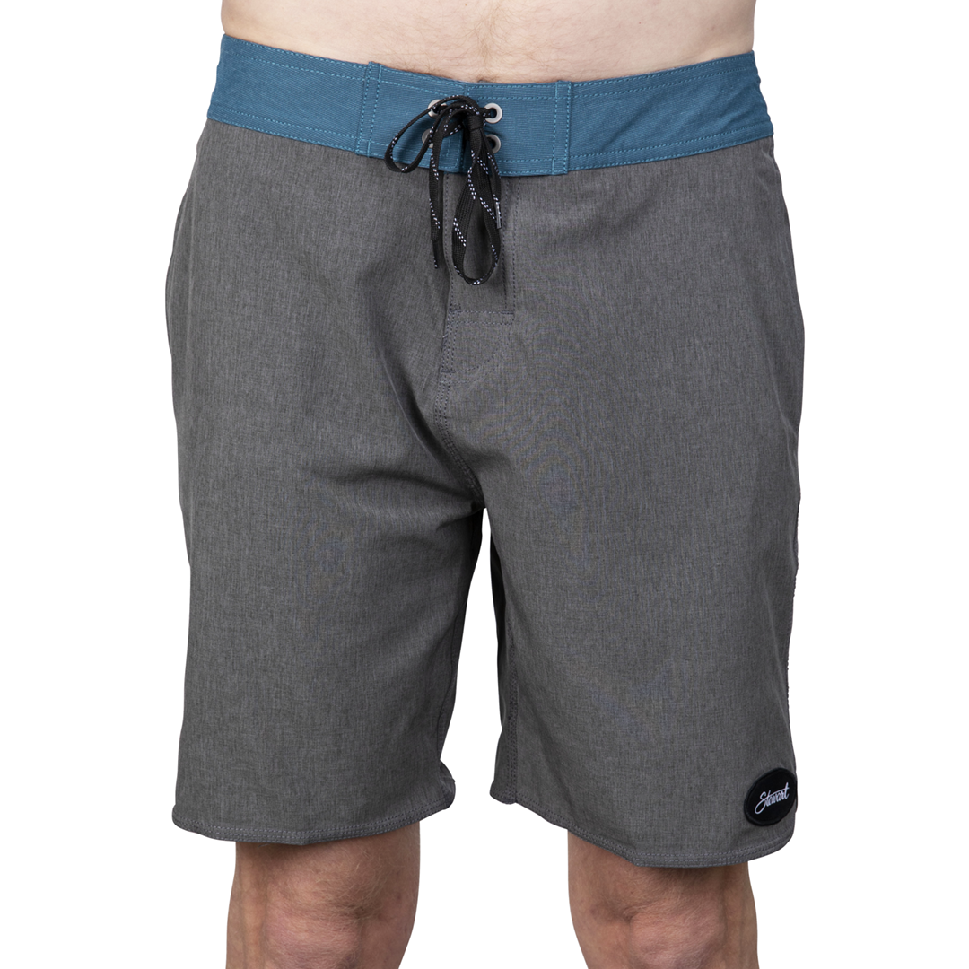 Front view of heather grey with teal waistband boardshorts on model