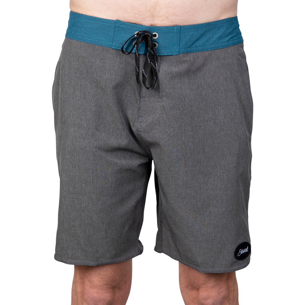 Front view of heather grey with teal waistband boardshorts on model