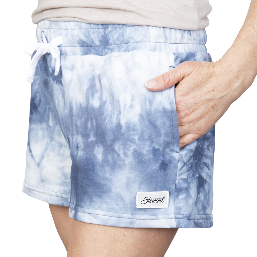 Front view of navy tie-dye shorts on model