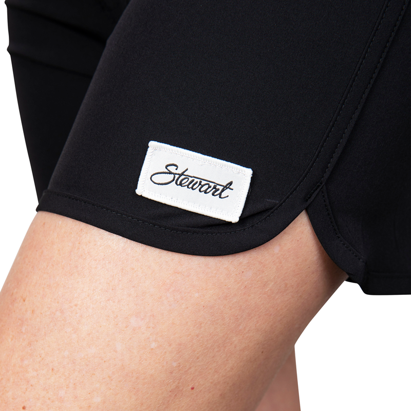 Detail view of classic black boardshorts on model