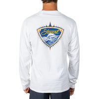 A man wearing a white long-sleeve t-shirt, viewed from the back. The shirt features a large shield-shaped graphic on the upper back with a blue ocean wave, yellow lettering that reads 'Stuart', and a red and yellow flame-like border.