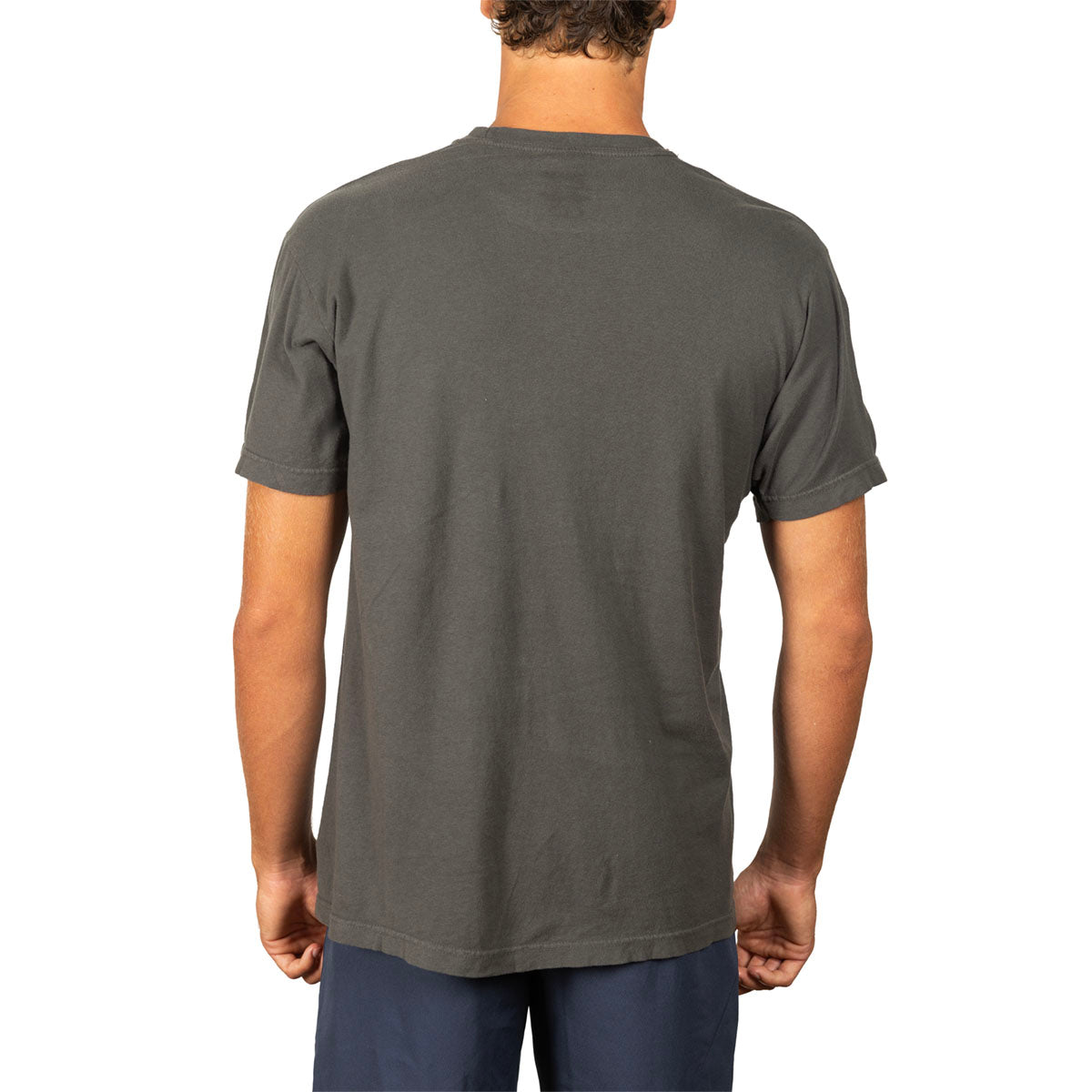 A man viewed from the back wearing a dark gray crewneck t-shirt and navy blue pants, set against a plain white background.