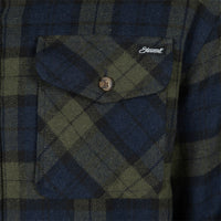Close-up of a plaid flannel shirt pocket with a button flap. The fabric features a dark blue, olive green, and black tartan pattern, with a small white embroidered 'Street' logo on the chest pocket.