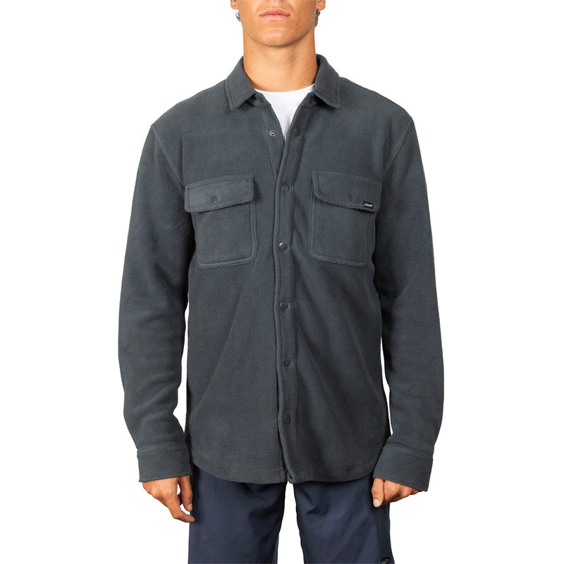 A man wearing a dark charcoal gray button-up shirt jacket with two chest flap pockets, photographed against a plain white background.
