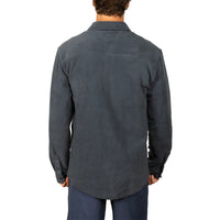 A man viewed from the back wearing a dark charcoal gray long-sleeve button-up shirt and navy pants, set against a plain white background.